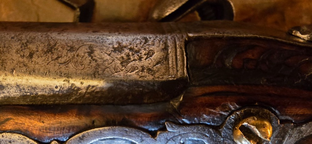 An 18th-century Balkan Ottoman flintlock holster pistol featuring a carved wooden stock, steel barrel, and a bulbous pommel. View X
