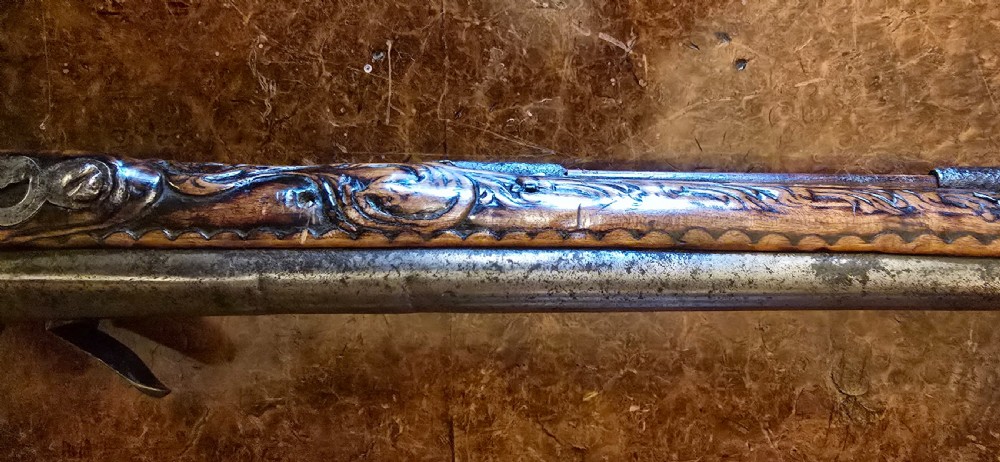An 18th-century Balkan Ottoman flintlock holster pistol featuring a carved wooden stock, steel barrel, and a bulbous pommel. View XII
