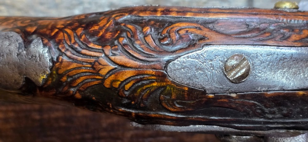 An 18th-century Balkan Ottoman flintlock holster pistol featuring a carved wooden stock, steel barrel, and a bulbous pommel. View XVI