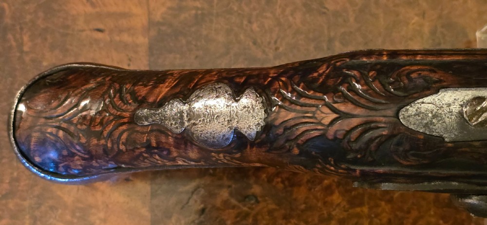 An 18th-century Balkan Ottoman flintlock holster pistol featuring a carved wooden stock, steel barrel, and a bulbous pommel. View XX