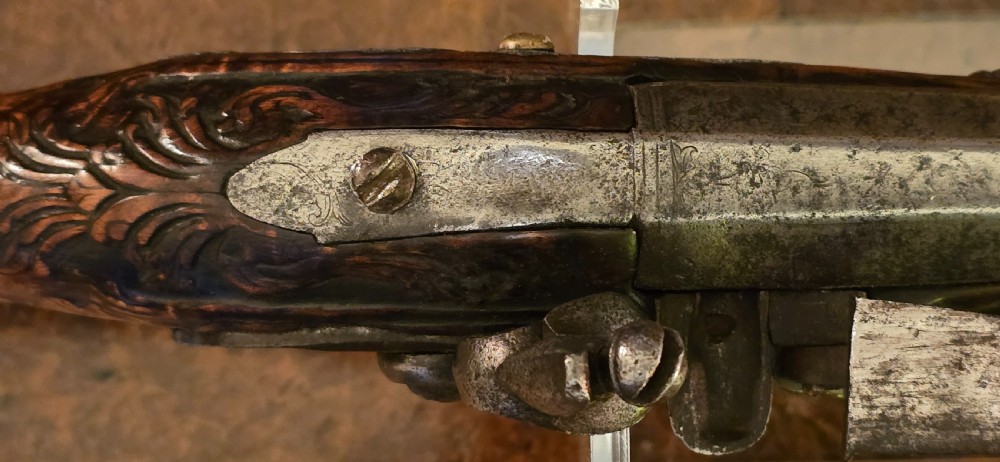 An 18th-century Balkan Ottoman flintlock holster pistol featuring a carved wooden stock, steel barrel, and a bulbous pommel. View XXI