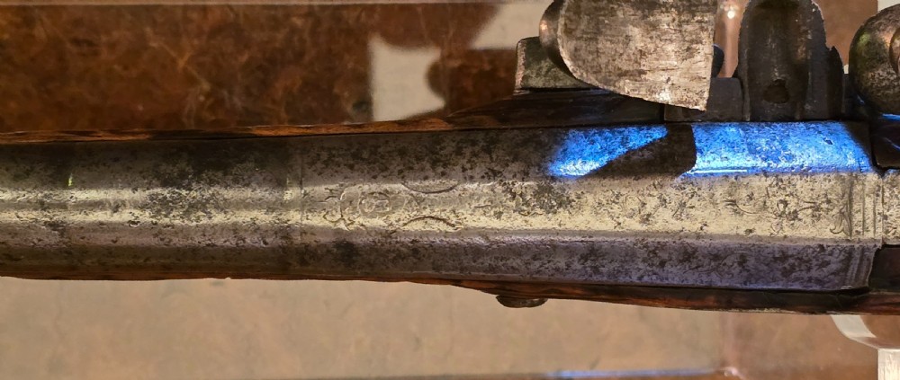 An 18th-century Balkan Ottoman flintlock holster pistol featuring a carved wooden stock, steel barrel, and a bulbous pommel. View XXII