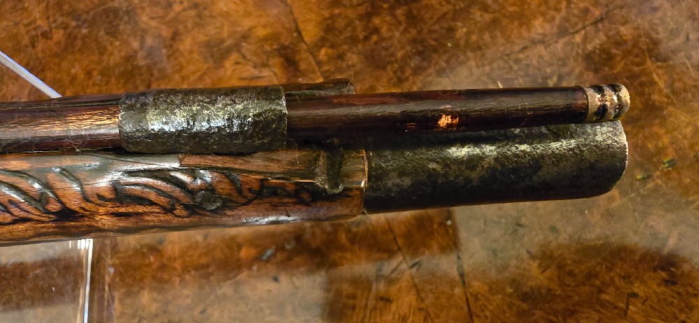 An 18th-century Balkan Ottoman flintlock holster pistol featuring a carved wooden stock, steel barrel, and a bulbous pommel. View XXVIII