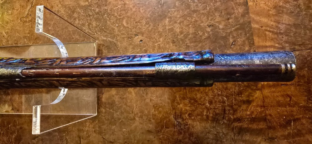 An 18th-century Balkan Ottoman flintlock holster pistol featuring a carved wooden stock, steel barrel, and a bulbous pommel. View XXIX