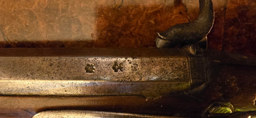 An 1840s percussion belt pistol featuring an engraved steel lockplate, octagonal barrel, and a carved walnut stock with a cross-hatched grip. View IV
