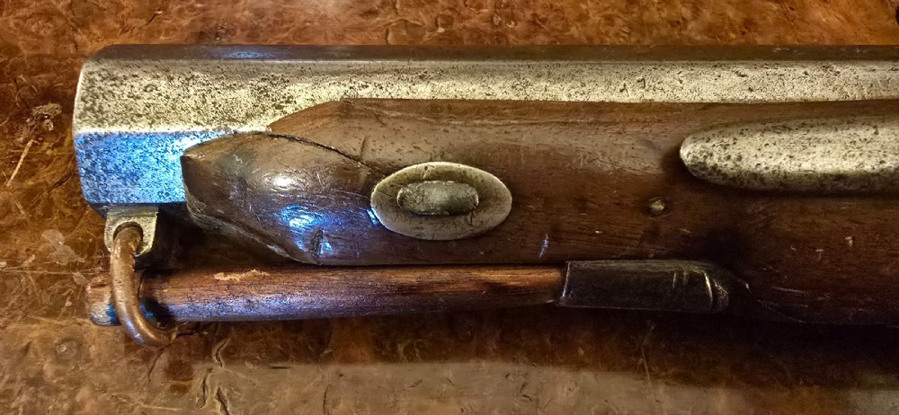 An 1840s percussion belt pistol featuring an engraved steel lockplate, octagonal barrel, and a carved walnut stock with a cross-hatched grip. View VIII