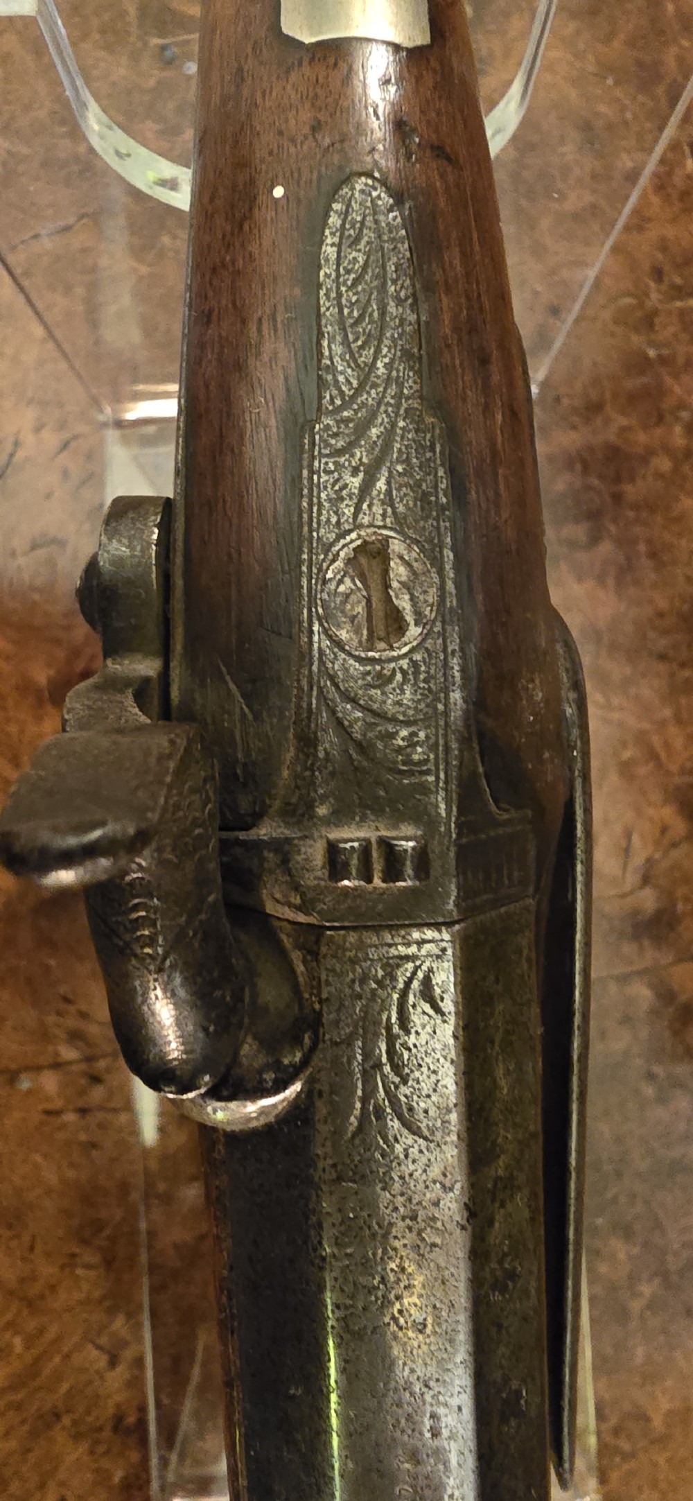 An 1840s percussion belt pistol featuring an engraved steel lockplate, octagonal barrel, and a carved walnut stock with a cross-hatched grip. View X