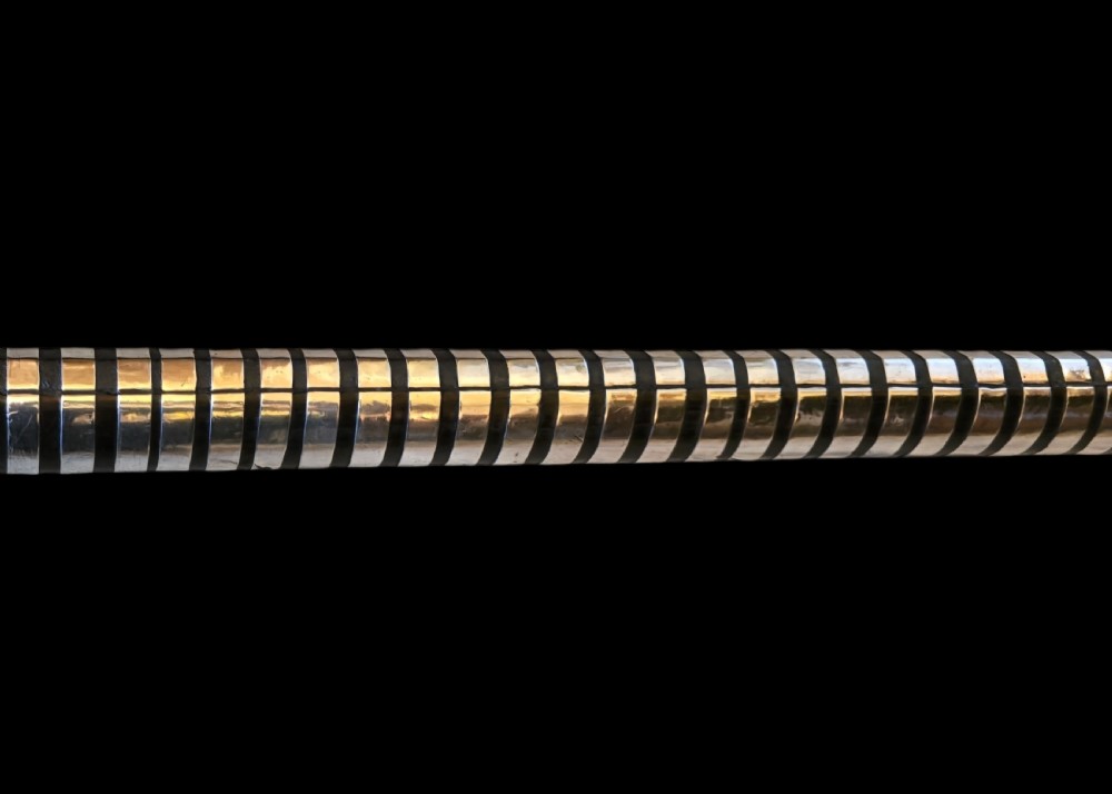 An 18th-century South Indian Torador matchlock musket featuring intricate silver sheet mounts, barrel bindings, and a dark carved wooden stock. View IV