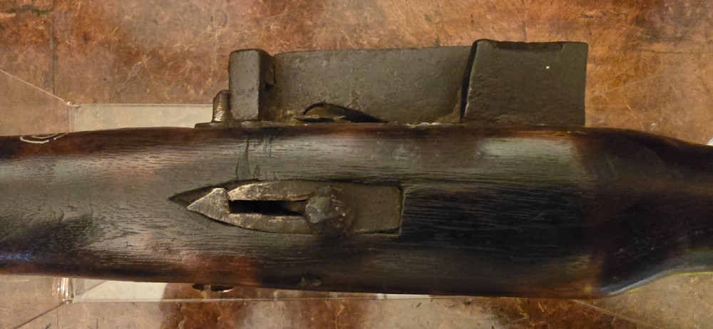 An antique dark wood snaphaunce flintlock pistol featuring intricate silver wire scrollwork inlay along the stock and a steel ignition mechanism. View XXVI