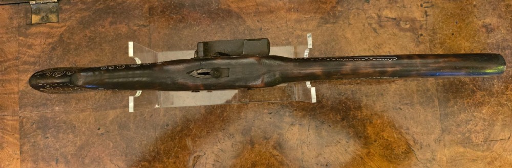 An antique dark wood snaphaunce flintlock pistol featuring intricate silver wire scrollwork inlay along the stock and a steel ignition mechanism. View XXVII