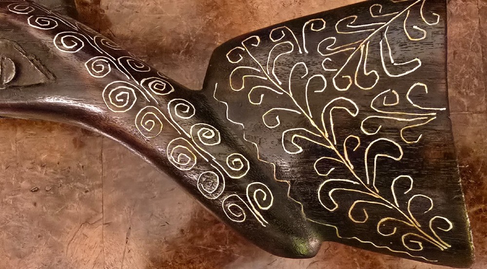 An antique dark wood snaphaunce flintlock pistol featuring intricate silver wire scrollwork inlay along the stock and a steel ignition mechanism. View XXX