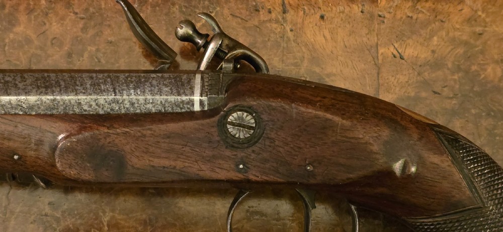 A Georgian British flintlock pocket pistol with a short octagonal barrel. Silver band & cartouche (not hallmarked), by 
Sutherland of London.  View XVIII