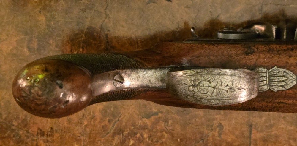 A Georgian British flintlock pocket pistol with a short octagonal barrel. Silver band & cartouche (not hallmarked), by 
Sutherland of London.  View XXV