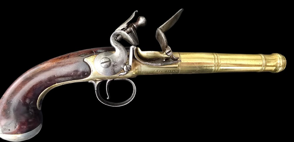 A pair of 18th-century English flintlock turn-off pistols featuring brass cannon barrels, steel lock mechanisms, and smooth walnut stocks. View XII