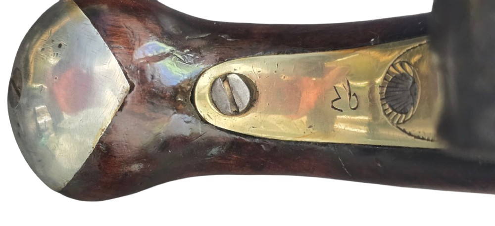A pair of 18th-century English flintlock turn-off pistols featuring brass cannon barrels, steel lock mechanisms, and smooth walnut stocks. View XVIII