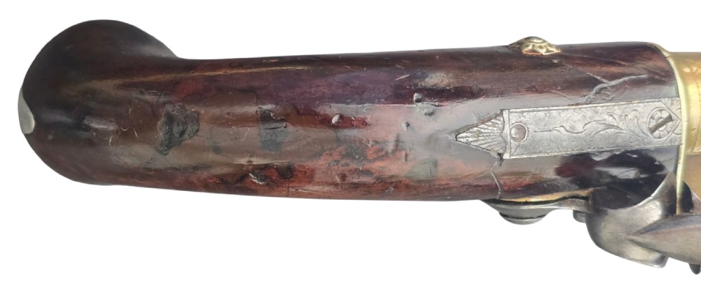 A pair of 18th-century English flintlock turn-off pistols featuring brass cannon barrels, steel lock mechanisms, and smooth walnut stocks. View XIX