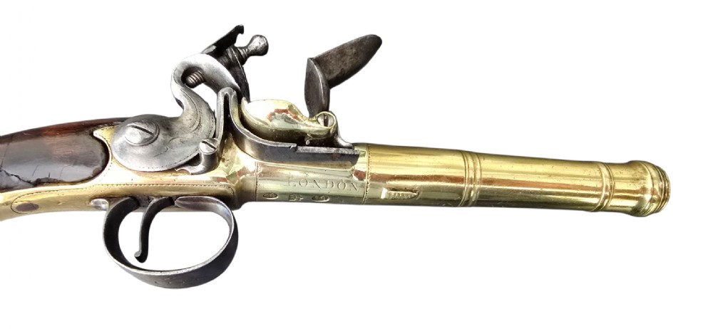 A pair of 18th-century English flintlock turn-off pistols featuring brass cannon barrels, steel lock mechanisms, and smooth walnut stocks. View XXII