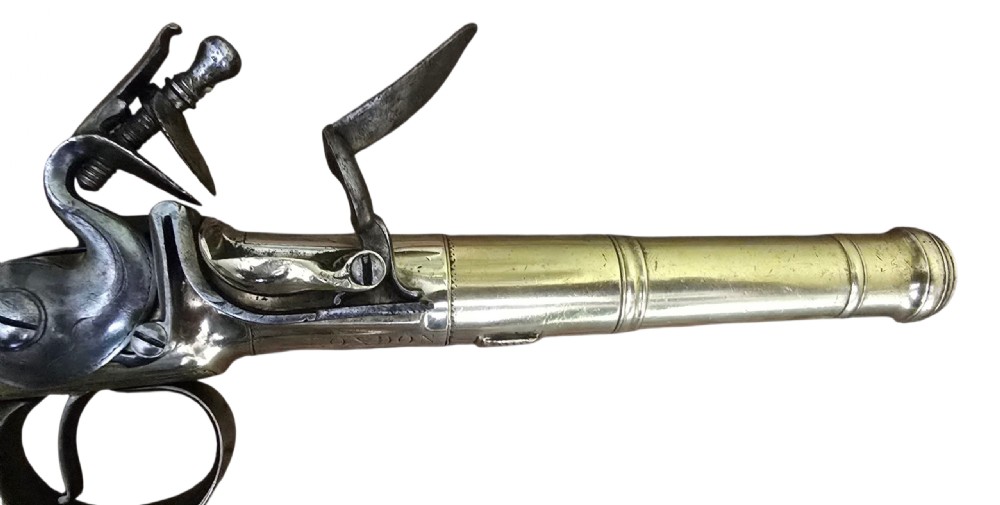 A pair of 18th-century English flintlock turn-off pistols featuring brass cannon barrels, steel lock mechanisms, and smooth walnut stocks. View XXIX