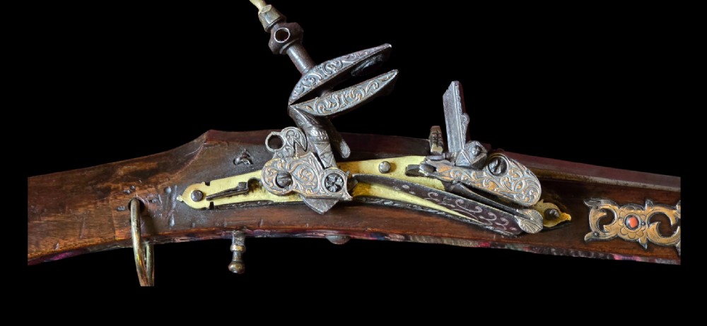 An 18th century Ottoman Algerian toe-lock long gun featuring a slender wooden stock decorated with brass bands and bone inlays. View II