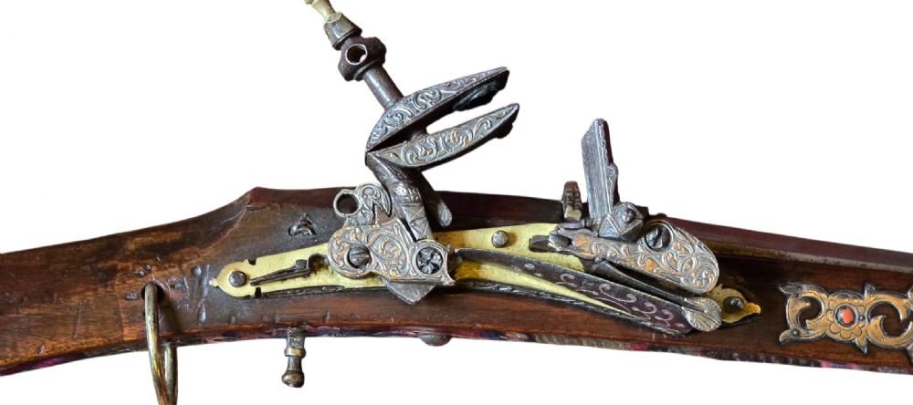 An 18th century Ottoman Algerian toe-lock long gun featuring a slender wooden stock decorated with brass bands and bone inlays. View VIII