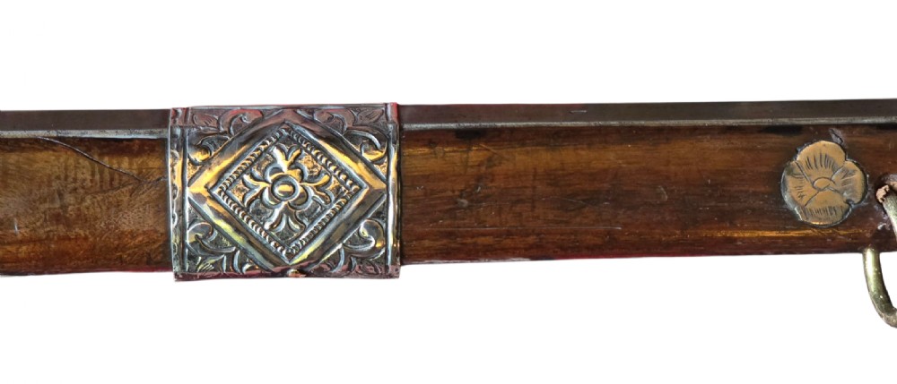 An 18th century Ottoman Algerian toe-lock long gun featuring a slender wooden stock decorated with brass bands and bone inlays. View IX