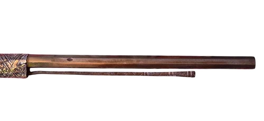 An 18th century Ottoman Algerian toe-lock long gun featuring a slender wooden stock decorated with brass bands and bone inlays. View XV