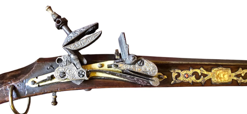 An 18th century Ottoman Algerian toe-lock long gun featuring a slender wooden stock decorated with brass bands and bone inlays. View XVIII