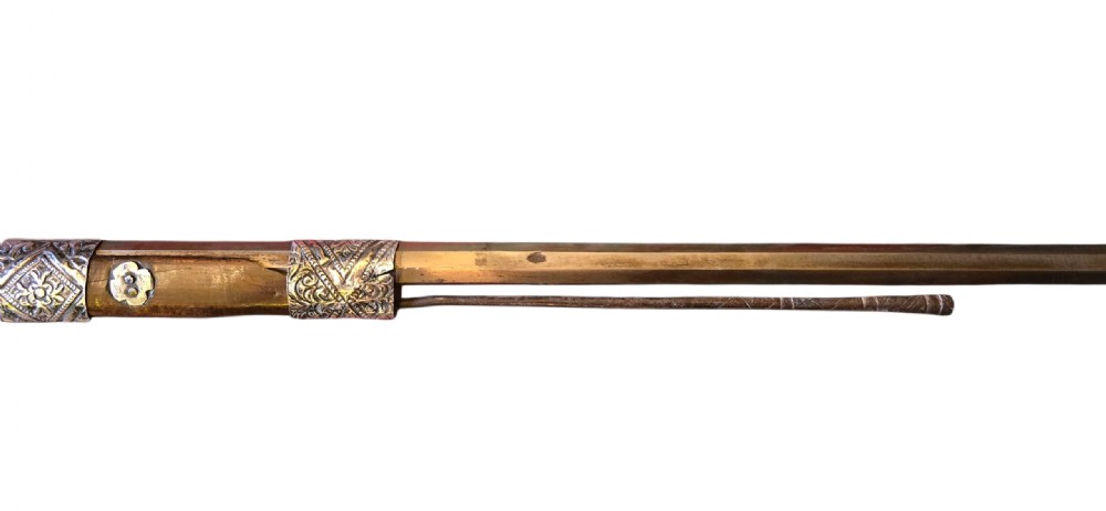 An 18th century Ottoman Algerian toe-lock long gun featuring a slender wooden stock decorated with brass bands and bone inlays. View XIX
