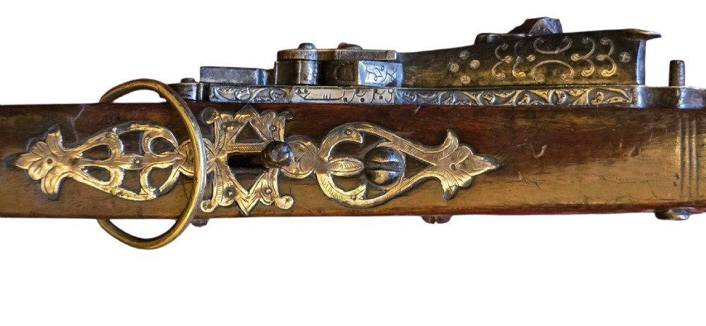 An 18th century Ottoman Algerian toe-lock long gun featuring a slender wooden stock decorated with brass bands and bone inlays. View XXI