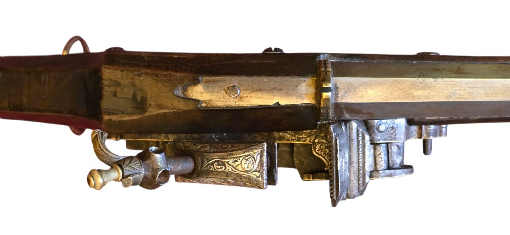 An 18th century Ottoman Algerian toe-lock long gun featuring a slender wooden stock decorated with brass bands and bone inlays. View XXVI