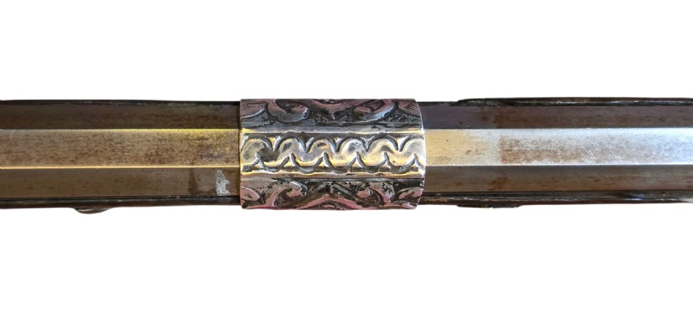 An 18th century Ottoman Algerian toe-lock long gun featuring a slender wooden stock decorated with brass bands and bone inlays. View XXX