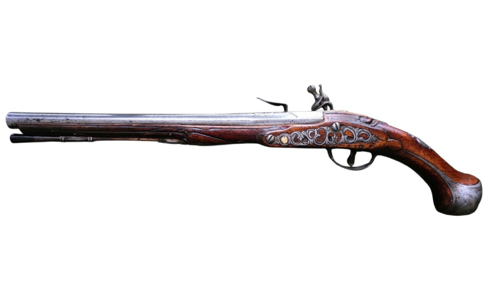 Fine German 18th C. Flintlock Holster Pistol by Hofmann, c.1750. With an ornately carved Walnut stock & brass lockplate.  View V