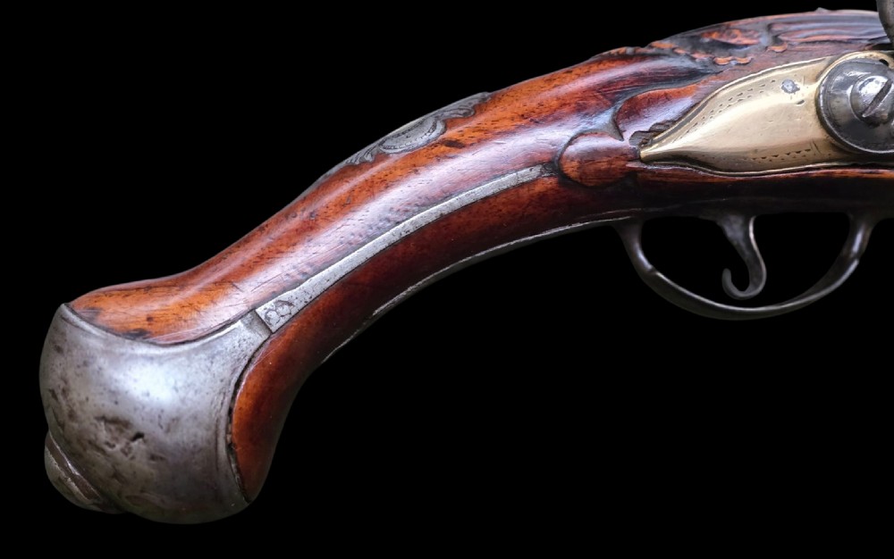 Fine German 18th C. Flintlock Holster Pistol by Hofmann, c.1750. With an ornately carved Walnut stock & brass lockplate.  View XVI