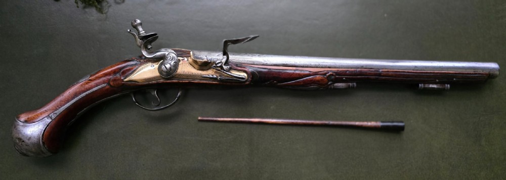 Fine German 18th C. Flintlock Holster Pistol by Hofmann, c.1750. With an ornately carved Walnut stock & brass lockplate.  View XVII