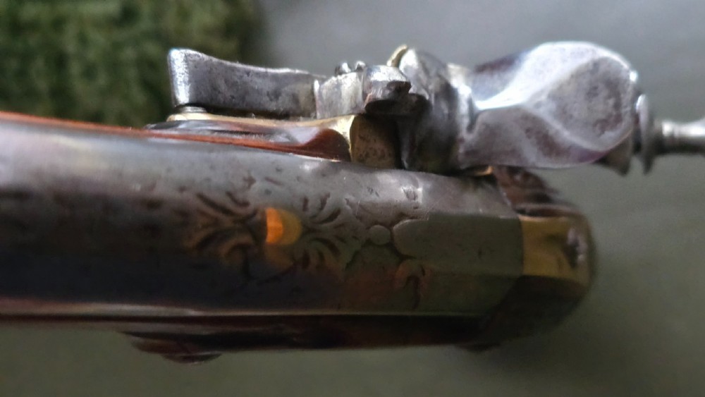 Fine German 18th C. Flintlock Holster Pistol by Hofmann, c.1750. With an ornately carved Walnut stock & brass lockplate.  View XVIII
