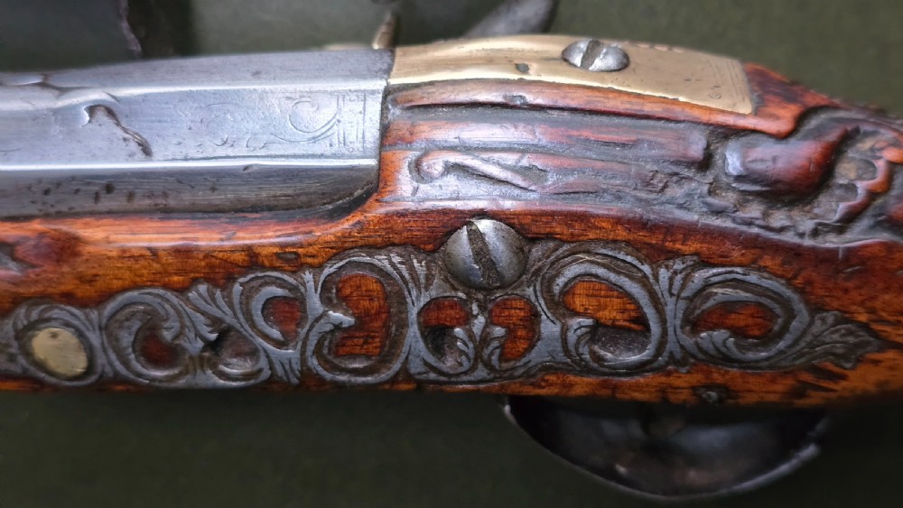 Fine German 18th C. Flintlock Holster Pistol by Hofmann, c.1750. With an ornately carved Walnut stock & brass lockplate.  View XXII