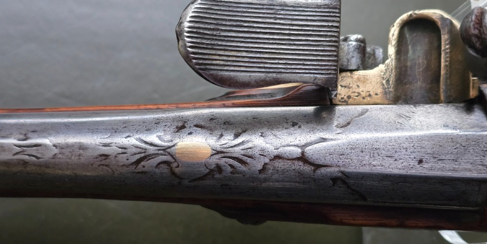 Fine German 18th C. Flintlock Holster Pistol by Hofmann, c.1750. With an ornately carved Walnut stock & brass lockplate.  View XXIV