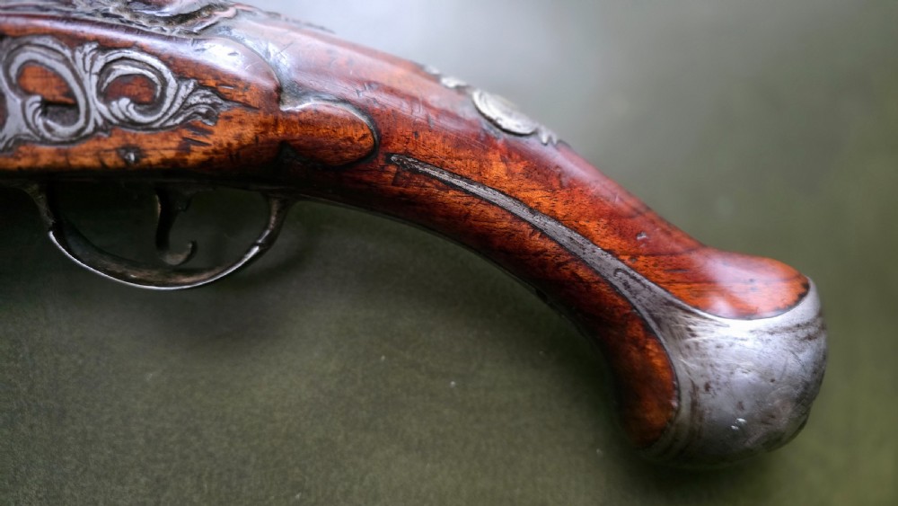 Fine German 18th C. Flintlock Holster Pistol by Hofmann, c.1750. With an ornately carved Walnut stock & brass lockplate.  View XXVII
