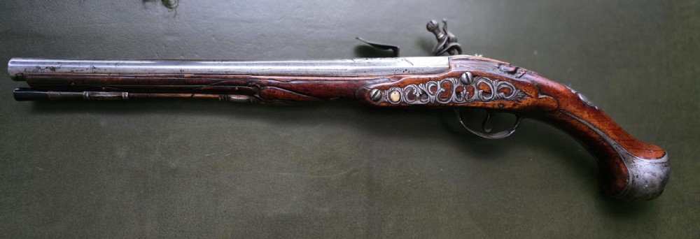 Fine German 18th C. Flintlock Holster Pistol by Hofmann, c.1750. With an ornately carved Walnut stock & brass lockplate.  View XXVIII