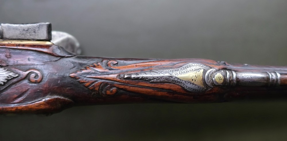 Fine German 18th C. Flintlock Holster Pistol by Hofmann, c.1750. With an ornately carved Walnut stock & brass lockplate.  View XXIX