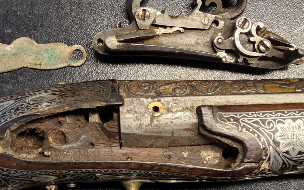A 19th-century Ottoman flintlock holster pistol featuring intricate silver wire inlay along the wooden stock and barrel. View XVIII
