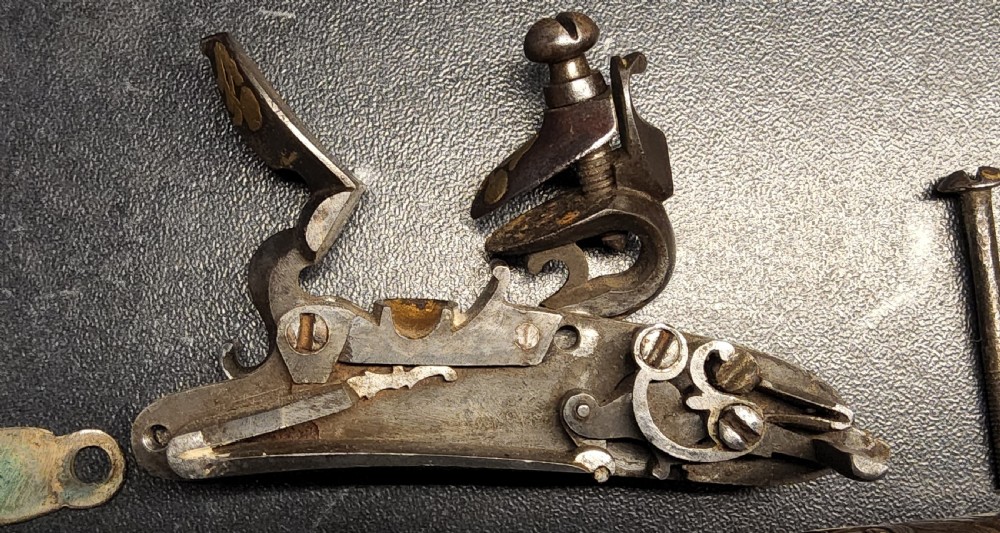 A 19th-century Ottoman flintlock holster pistol featuring intricate silver wire inlay along the wooden stock and barrel. View XIX
