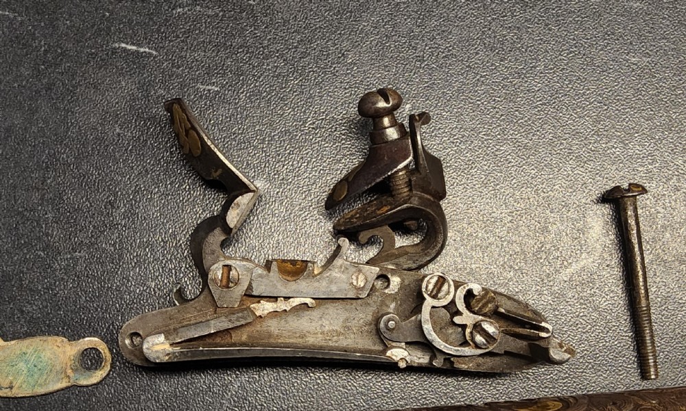 A 19th-century Ottoman flintlock holster pistol featuring intricate silver wire inlay along the wooden stock and barrel. View XXIII