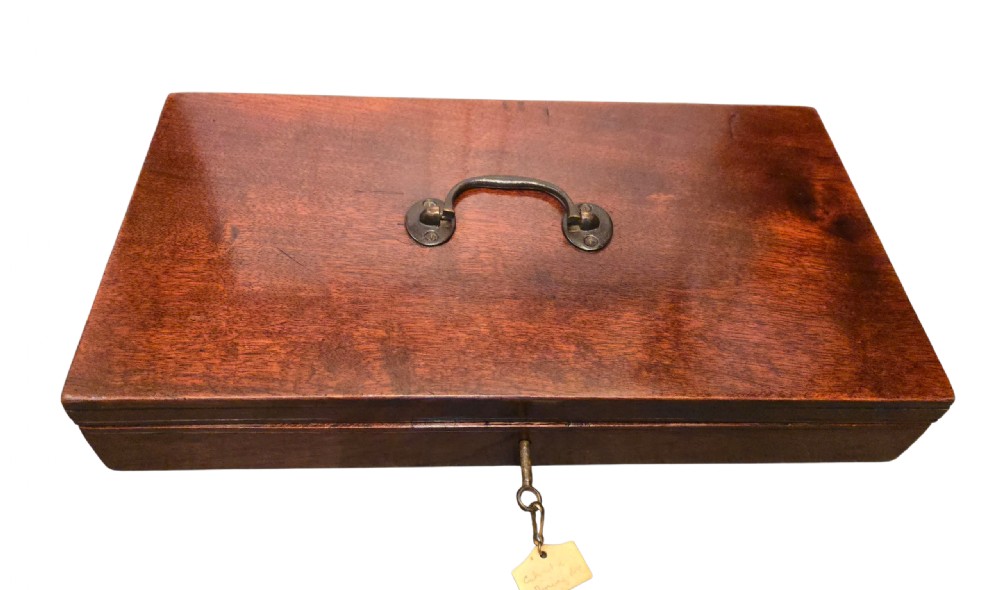 A fitted mahogany wooden case lined with green baize containing a pair of flintlock duelling pistols, a ramrod, and loading accessories. View IV