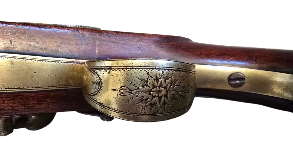 A fitted mahogany wooden case lined with green baize containing a pair of flintlock duelling pistols, a ramrod, and loading accessories. View XII
