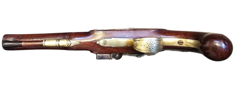 A fitted mahogany wooden case lined with green baize containing a pair of flintlock duelling pistols, a ramrod, and loading accessories. View XIII