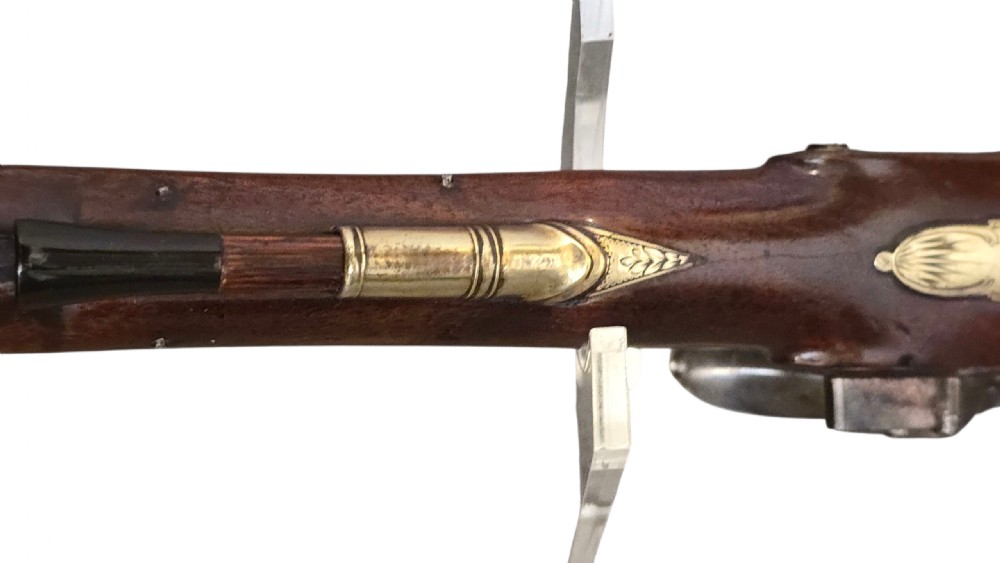 A fitted mahogany wooden case lined with green baize containing a pair of flintlock duelling pistols, a ramrod, and loading accessories. View XVI
