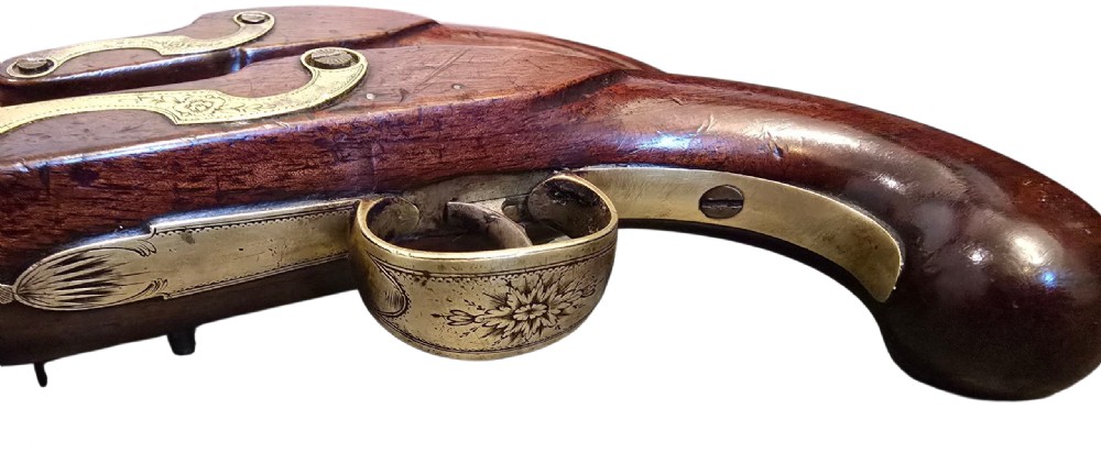 A fitted mahogany wooden case lined with green baize containing a pair of flintlock duelling pistols, a ramrod, and loading accessories. View XXVIII