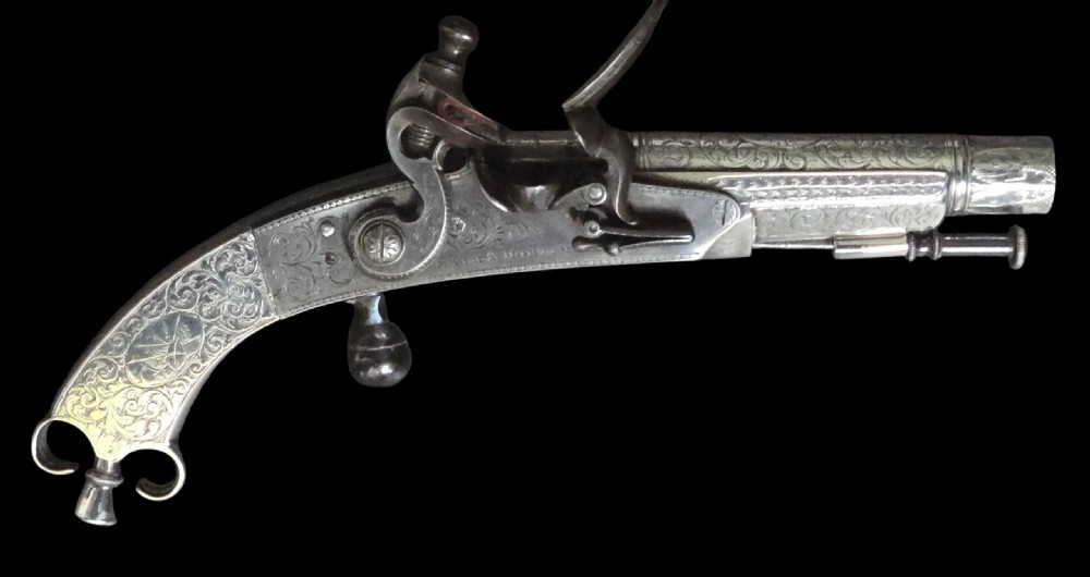 An eighteenth-century Scottish flintlock pocket pistol crafted in silver with intricate scroll engraving and a steel firing mechanism.
