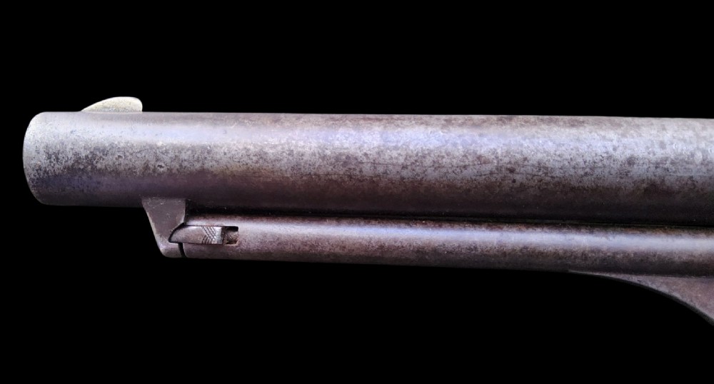 Side profile of a patinated steel Colt Model 1860 Army percussion revolver featuring a walnut handle grip and brass trigger guard. View XV